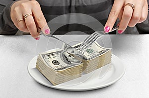 Hands Cut money on plate, cut budget concept