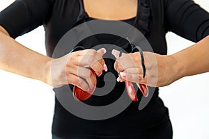 Hands detail of flamenco dancer in dress with castanets.