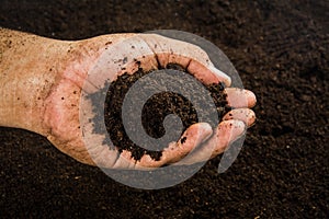 Hands dirty with clay , soil background