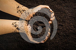 Hands dirty with clay , soil background