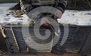 Hands dirty old street musician played on an old musical instrument