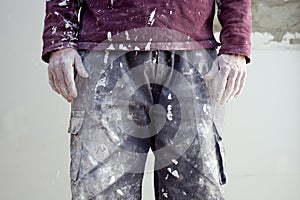 Hands dirty trousers of plastering painter man