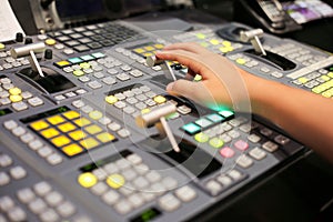 Hands on dissolve of Switcher buttons in studio TV station, Audi