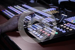 Hands on dissolve of Switcher buttons in studio TV station  Audio and Video Production Switcher