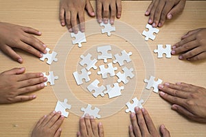 Hands of diverse people assembling jigsaw puzzle, Youth team put