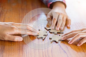 Hands of diverse people assembling jigsaw puzzle, Youth team put