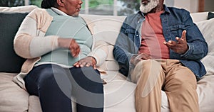 Hands, divorce and a senior couple arguing on a sofa in the living room of their home closeup. Stress, fighting or