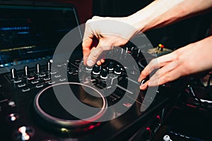 Hands of DJ controllers for music on professional mixer for mixing music