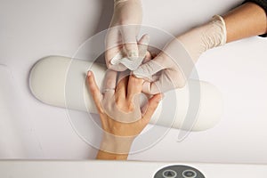 Hands of a doctor applying adhesive bandage on knee caucasian woman isolated white background.