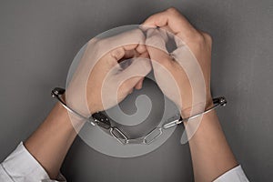 Hands of a doctor in handcuffs close up,arrest of a surgeon