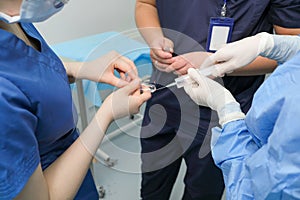 The hands of doctors fill the syringe with drugs from the ampoule