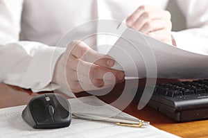 Hands with document on a computer keyboard