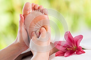 Hands doing foot reflexology.