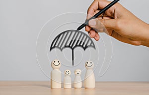 Hands drawing protecting family wooden human insurance