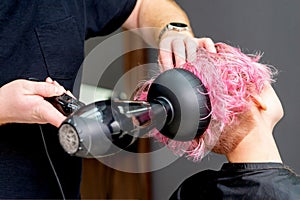 Hands dries hair of woman