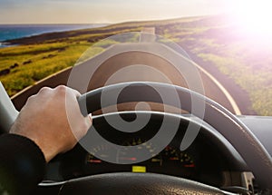 Hands of a driver on steering wheel of a car