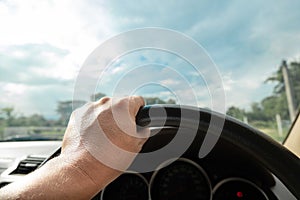 Hands driving a car in home town, safety drive and car insurance concept