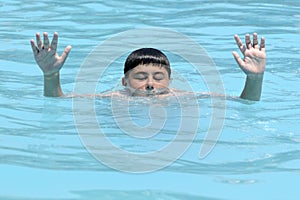 Hands of drowning boy