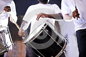 Hands, drum or festival with a band playing an instrument in a carnival in Rio de Janeiro, Brazil. Night show, person or