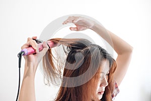 Hands drying woman hair with equipment.