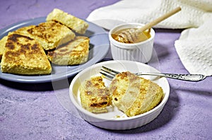 hands eating a harcha or mbasses semolina algerian pancakes on an arabesque colorful plate