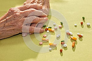 Hands of an elderly lady with medication photo