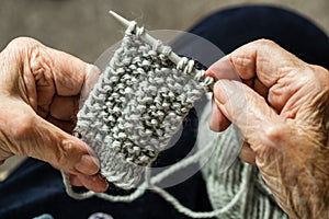 Hands of an elderly woman knitting