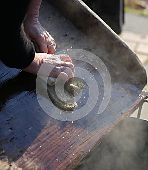 Hands of the elderly woman washing