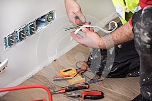 Hands of an electrician, electrician at work, handyman and electrical installation