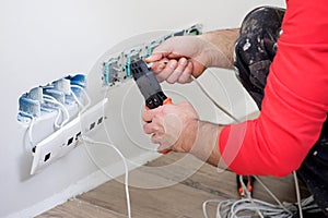 Hands of an electrician, electrician at work, handyman and electrical installation