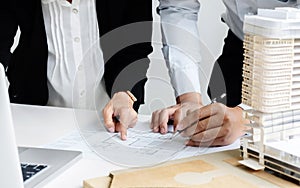 Hands of Engineers working on blueprint at a workplace, Construction and building concept