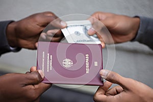 Hands Exchanging Passport For Banknote