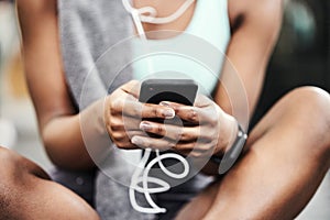 Hands, exercise and woman with smartphone, fitness and listen to music with break, relax and contact. Closeup, person or