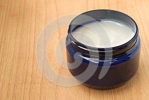 Hands and face cream in blue pot