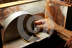 Hands during faceting of gemstone.