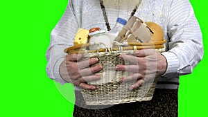 Hands of farmer holding basket of dairy products.