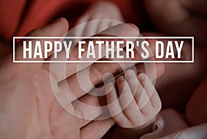 Hands of father and of newborn baby. Fathers day.