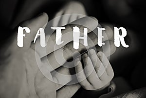 Hands of father and of newborn baby. Fathers day.