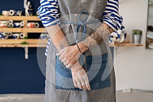 Hands of female artisan after working with raw clay in pottery studio. Pottery business and workshop