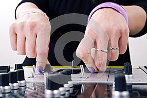 Hands of female DJ playing
