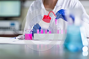Hands of a female researcher carrying out research in a lab