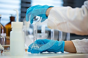 Hands of a female researcher doing research in a lab