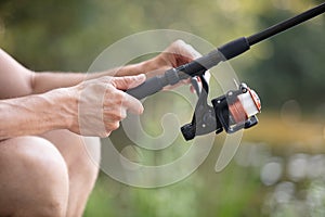 hands fisherman keep spinning rod