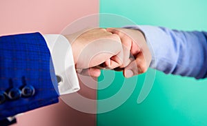 Hands fists of business people touch in gesture. Teamwork or good job symbol. Type of handshake or hand gesture with