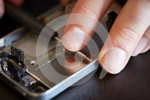 Hands fixing smartphone close-up