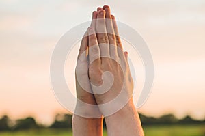 Hands folded in prayer concept for faith, spirituality and religion