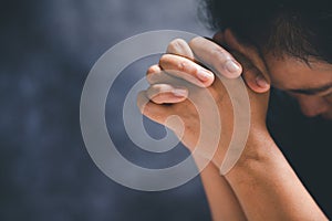 Hands folded in prayer on a Holy Bible in church concept for faith, spirituality and religion, woman praying on holy bible in the