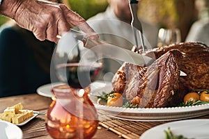 Hands, food and man with turkey on thanksgiving, lunch and meal at table with hungry people celebrate tradition. Family