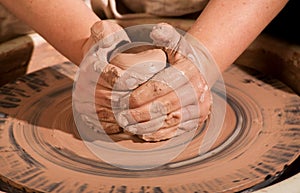 Hands forming clay