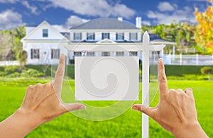 Hands Framing Blank Real Estate Sign and New House photo